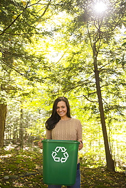 Woman holding recycling bin, Newtown, Connecticut