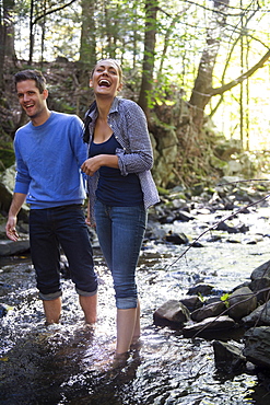 Couple wading in stream, Newtown, Connecticut