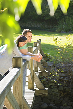 Couple standing on wooden bridge, Newtown, Connecticut