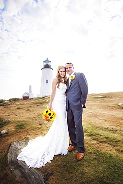 Portrait of married couple, lighthouse in background, USA, Maine, Bristol 