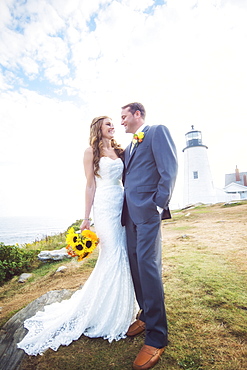 Portrait of married couple, lighthouse in background, USA, Maine, Bristol 