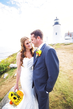 Portrait of married couple, lighthouse in background, USA, Maine, Bristol 