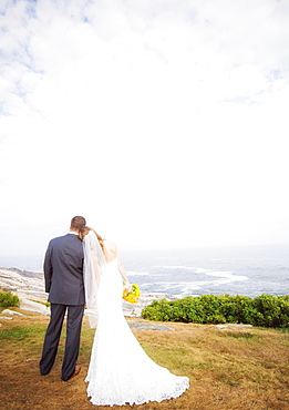 Rear view of married couple standing by sea, USA, Maine, Bristol 