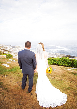 Rear view of married couple standing by sea, USA, Maine, Bristol 