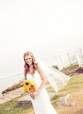 Portrait of bride holding sunflower bouquet, USA, Maine, Bristol 