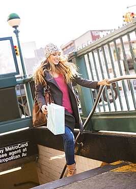 Portrait of blond woman leaving subway station, USA, New York City, Brooklyn, Williamsburg