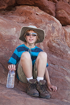 Young boy (10-11) hiking, USA, Utah, Arches National Park, Moab