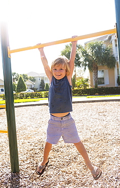 Boy (4-5) playing on playground, Jupiter, Florida, USA