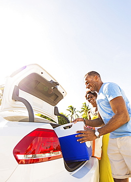 Mature couple loading car trunk, Jupiter, Florida