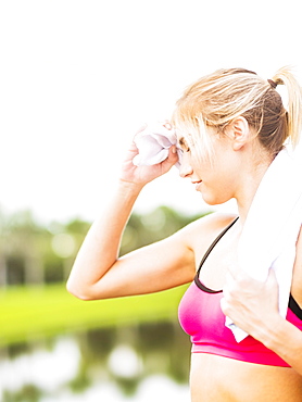 Woman whipping sweat off forehead, Jupiter, Florida