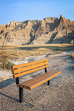 Empty bench with amazing rock formation in the background, USA, South Dakota, Badlands National Park