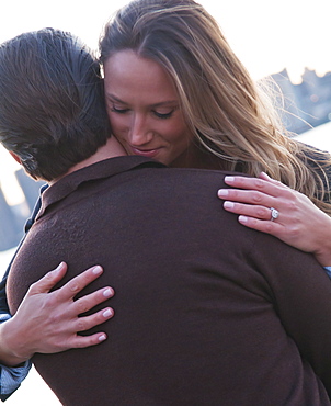 USA, New York, Long Island City, Young couple embracing outdoors