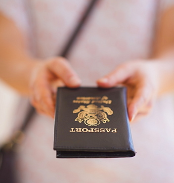 Close up of woman's hands holding passport