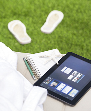 Digital tablet and notebook on lounger, USA, New Jersey, Jersey City