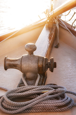 Rope coiled on yacht bow in sunset light