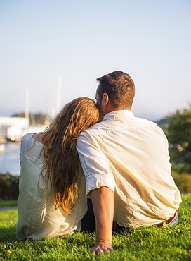 Back view of couple looking at harbor, Camden, Maine