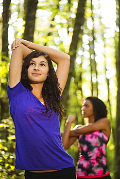 Two young women stretching, USA, Oregon, Portland