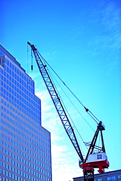 Crane and high-rise under blue sky