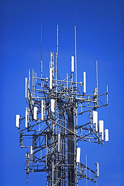 Communications tower under blue sky