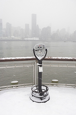 USA, New York City, coin operated binoculars overlooking foggy Manhattan