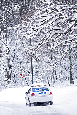 USA, New York City, police car on snowy road