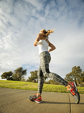 Woman running in park, Irvine, California