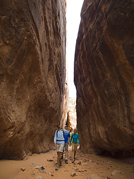 People hiking between rock formations