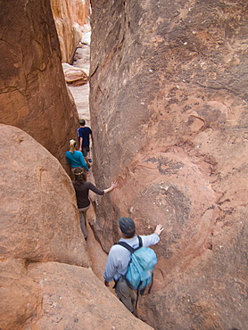 People walking through rock formations