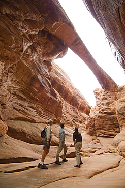 People looking up at rock formations