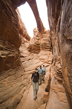 People looking up at rock formations