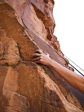 Close up of womanâ€™s arm rock climbing