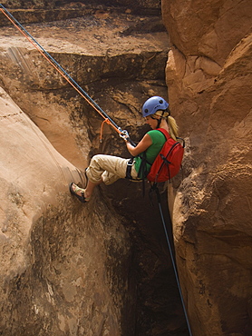 Woman canyon rappelling