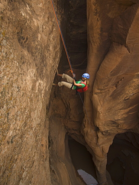 Woman canyon rappelling