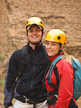 Couple wearing rappelling gear