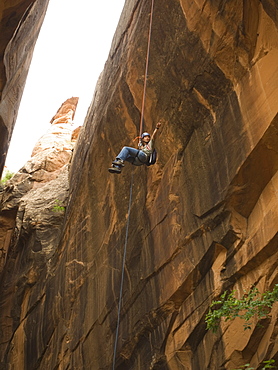 Woman canyon rappelling