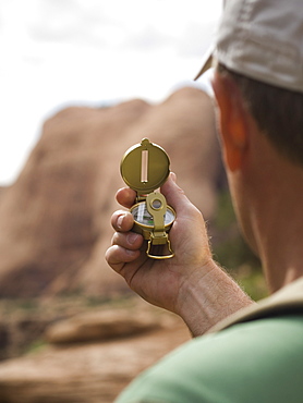 Man looking at compass