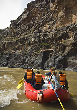 Group of people river rafting