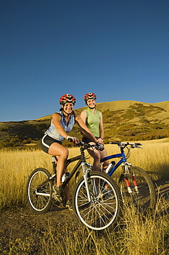 Two women on mountain bikes, Salt Flats, Utah, United States