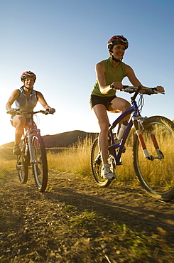 Two women riding mountain bikes, Salt Flats, Utah, United States