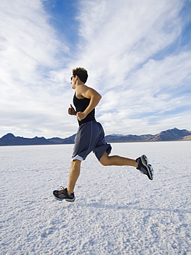 Man running on salt flats, Utah, United States