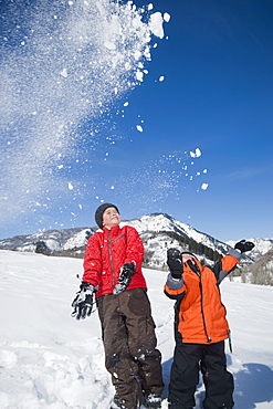 Brothers playing in snow