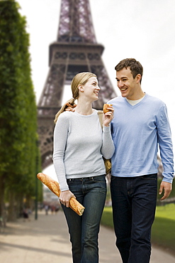 Couple walking with Eiffel Tower in background