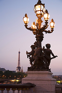 Lamp post with cherubs with Eiffel Tower in background