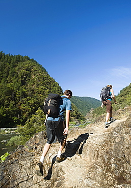 Hikers walking on riverside trail