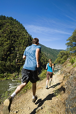 Runners on riverside trail