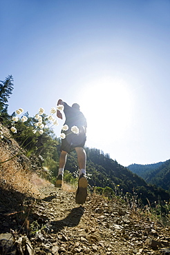 Man running on steep trail