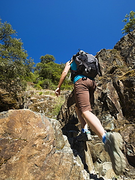 Hiker ascending rocky trail