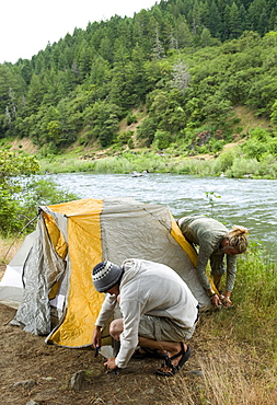 Couple preparing campsite