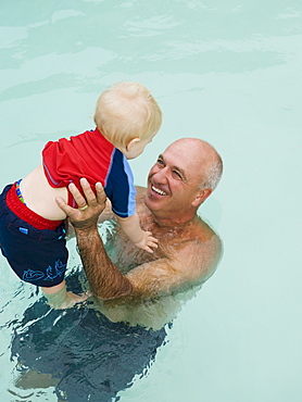 Grandfather and grandson in swimming pool