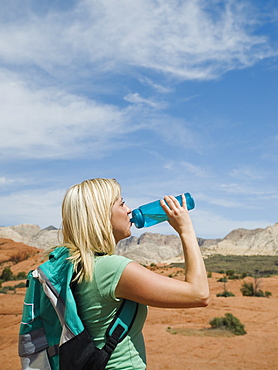 A woman at Red Rock drinking water